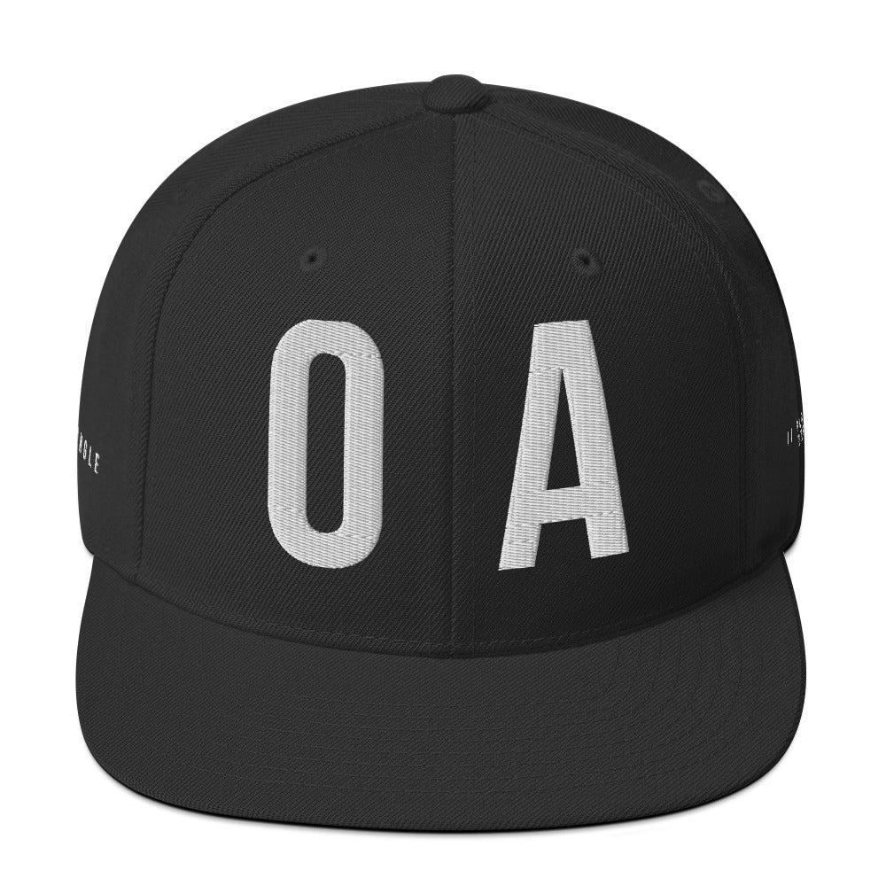 OFF<ANGLE Out Of Position Cap Black premium snapback cap from the ILLEGAL ANGLES collection with oversized white O A front embroidery